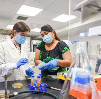 Faculty providing hands-on instruction in lab