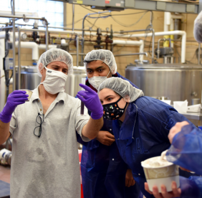 Creamery staff working with students in Creamery