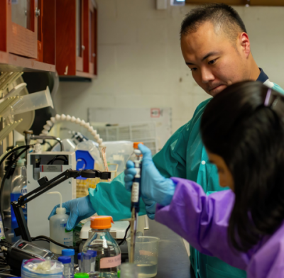 Faculty providing hands-on instruction in lab