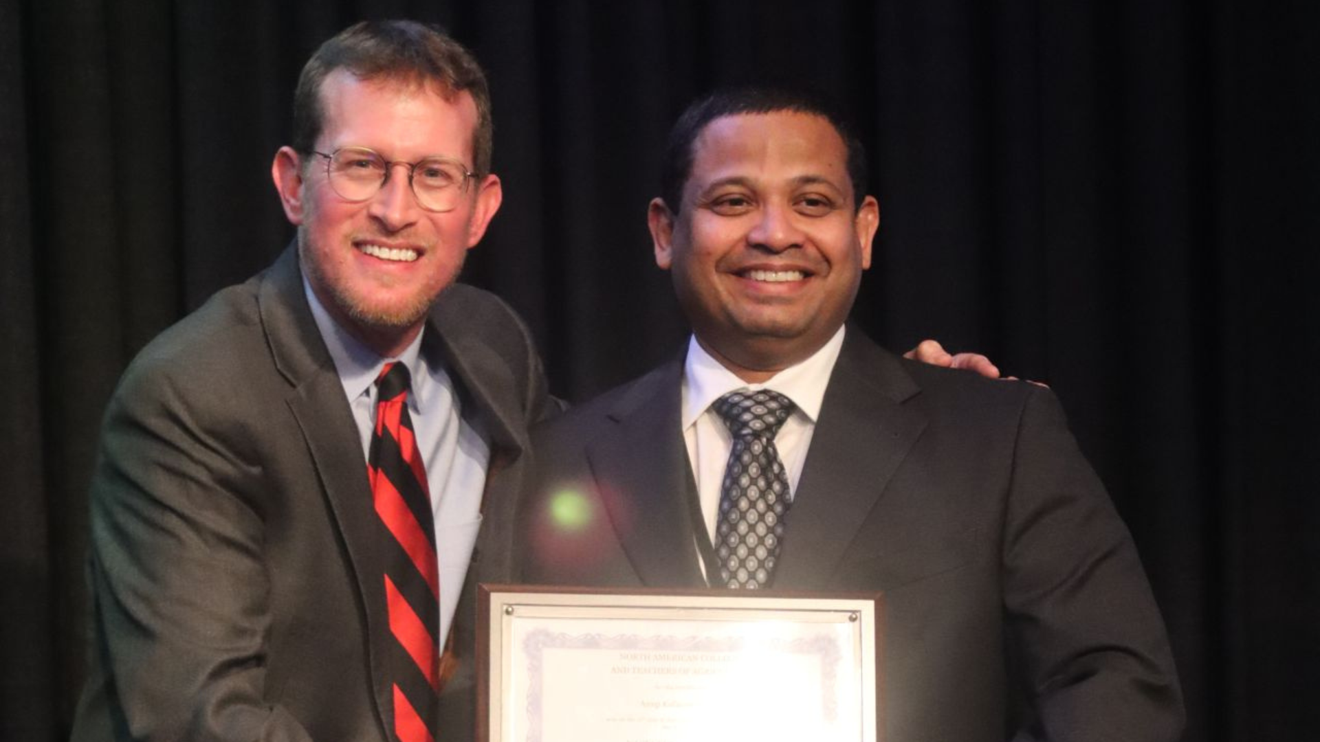 Dr. Anup Johny posing for a photo alongside a colleague.