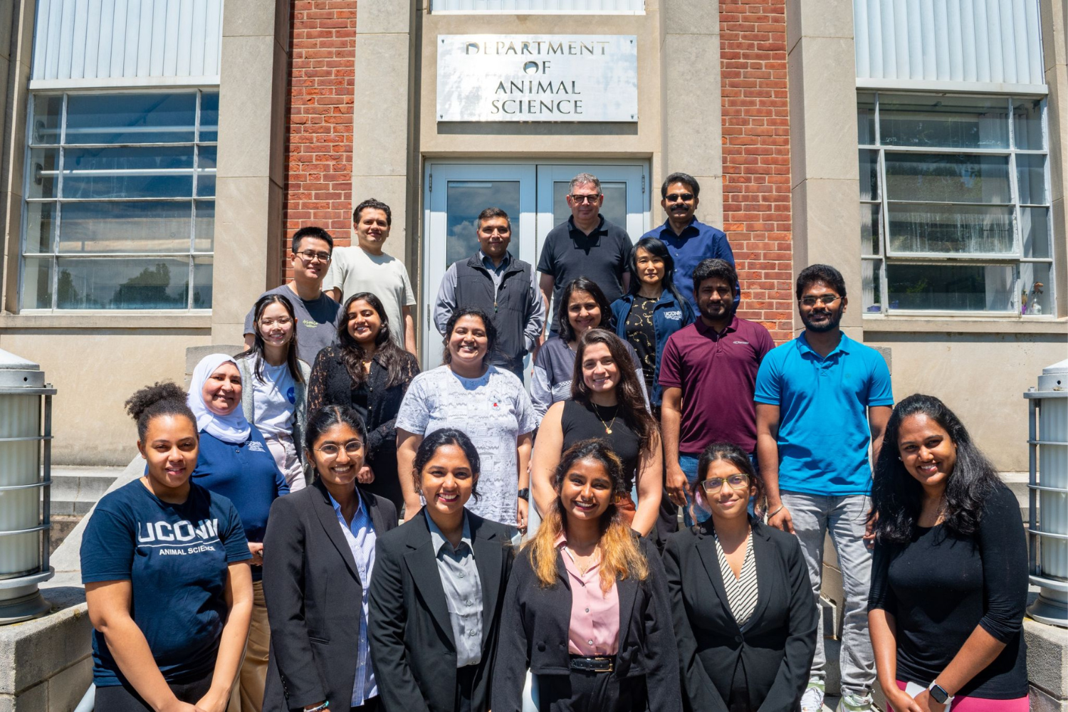 Students pose for photo outside of the George White Building.