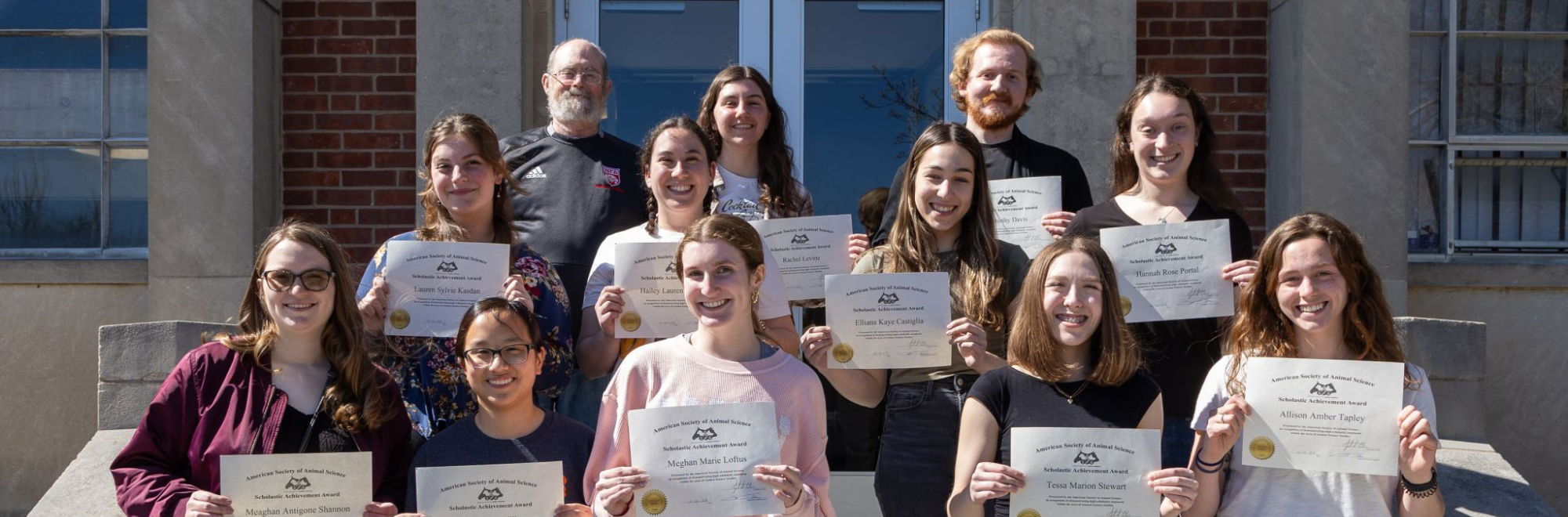 Students posing outside of the George White Building