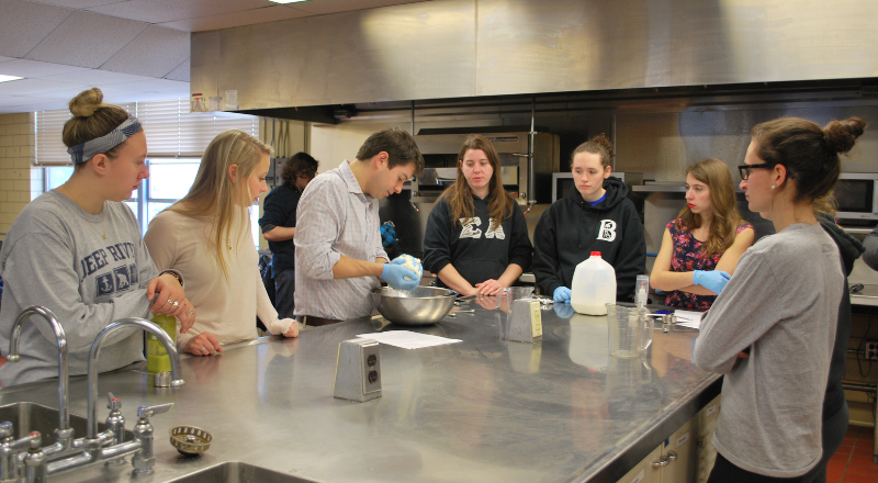 Dennis D'Amico guiding students through the process of making cheese